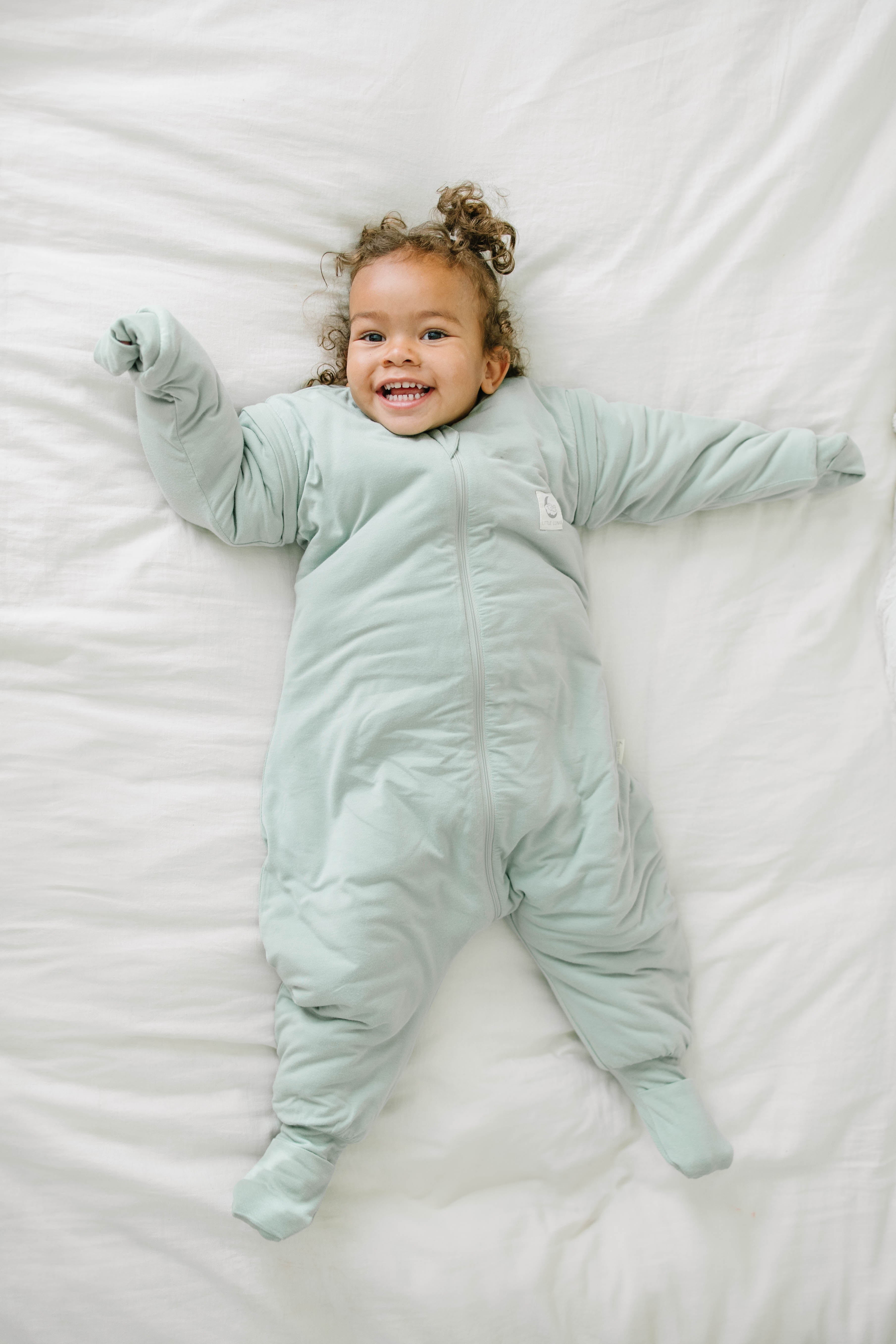 Happy toddler in bamboo walker sleeping bag
