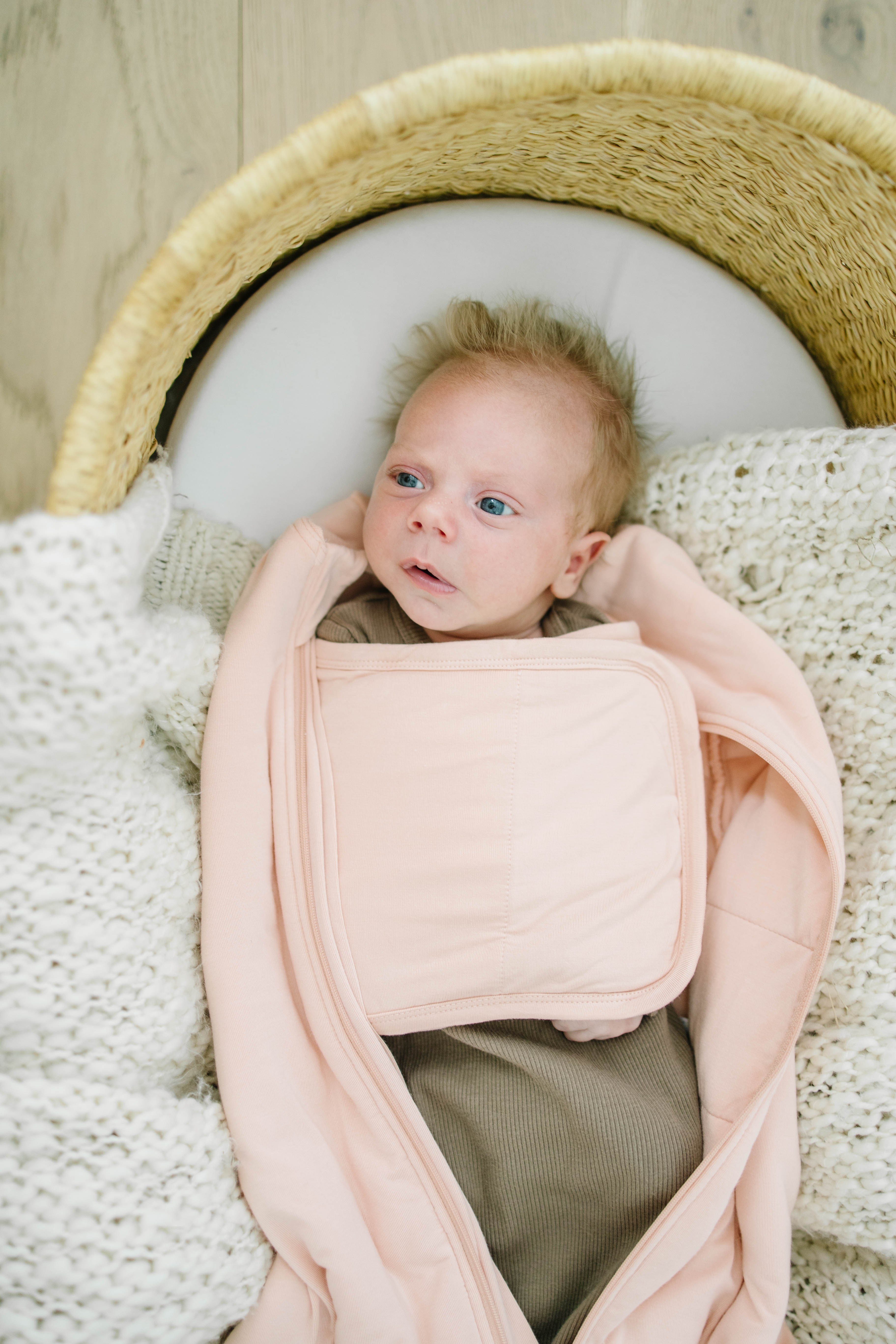 Baby swaddled comfortably in eco-friendly bamboo sleeping bag